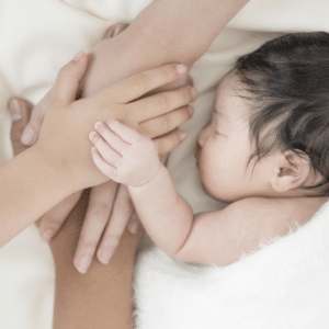 family sleeping holding hands