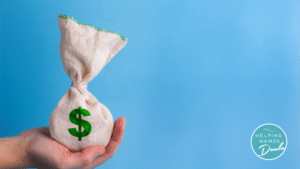 Person holding a bag with a money sign