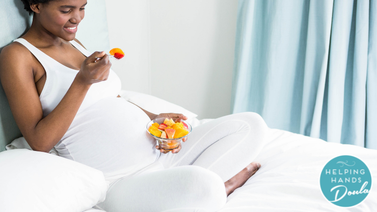 Woman Pregnant and eating healthy meal in bed