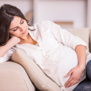 Pregnant woman sitting and thinking