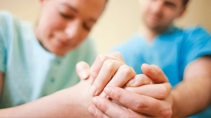 birthing parent holding a hand for support