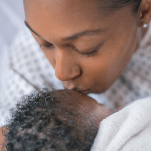black mother kissing baby