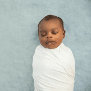 black baby swaddled to provide comfort