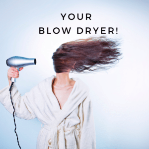 woman blow drying her hair