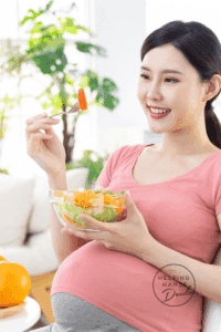 Pregnant woman enjoying a salad