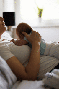 New mother reclined with newborn on her chest tummy to tummy.