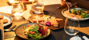 Table setting, glassware, plated food, candlelight