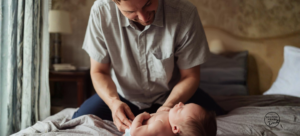 new dad changing newborn diaper